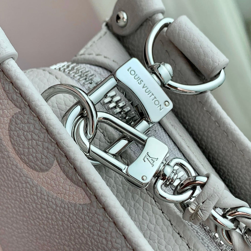 LOUIS VUITTON ONTHEGO EAST WEST BAG 25 IN BICOLOR MONOGRAM EMPREINTE LEATHER