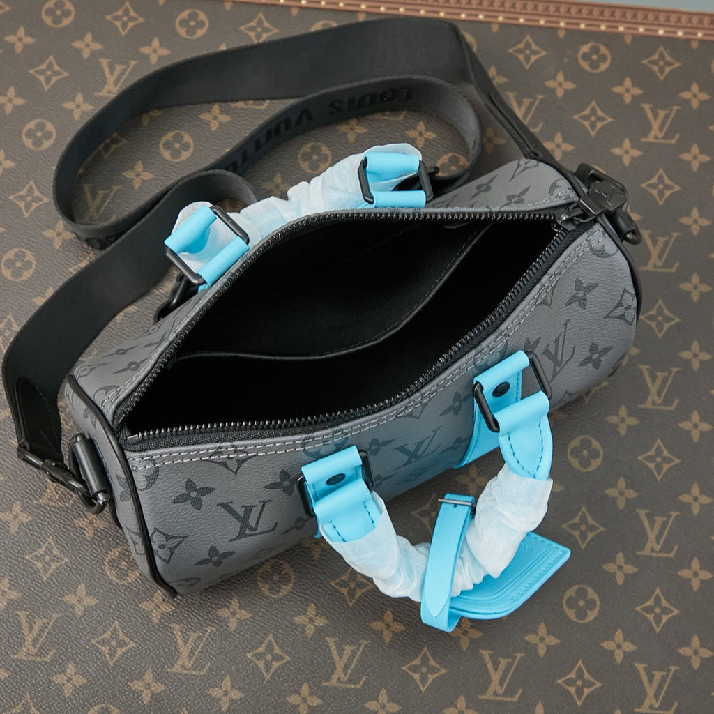 LOUIS VUITTON KEEPALL BANDOULIÈRE 25 IN GUN METAL MONOGRAM ECLIPSE CANVAS MIX TURQUOISE CALFSKIN